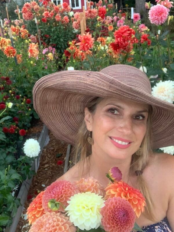 Woman cutting dahlias at Dynomite Farm, a private Santa Cruz flower farm